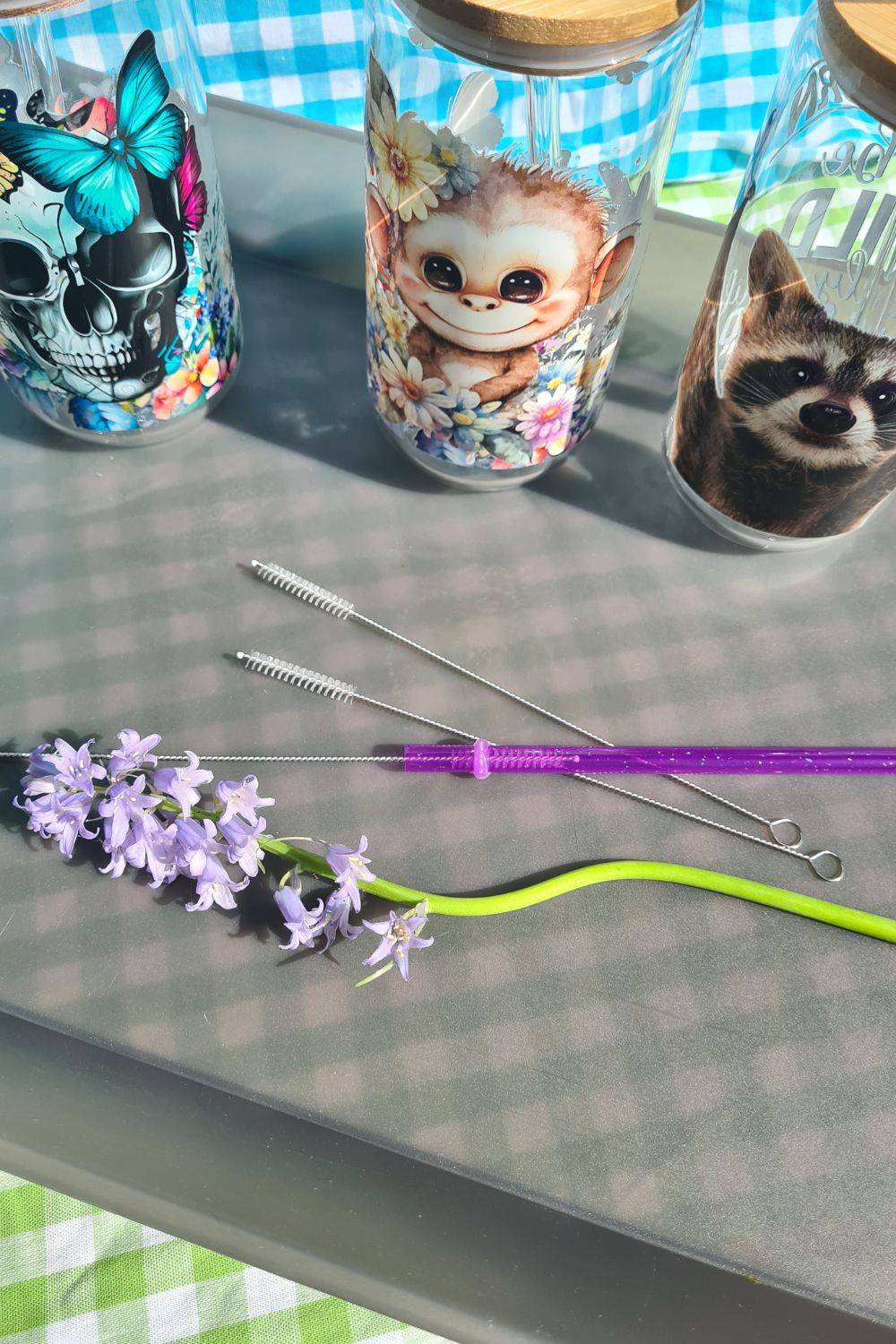 a purple flower in a vase on a table 